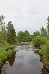 Fototapeta na wymiar Landscape view of river Hirvihaaranjoki in cloudy summer weather, Hirvihaara, Mäntsälä, Finland.