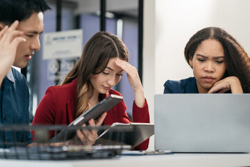 business people, teamwork, people and crisis concept - business team sitting sad and solving problems in the office.