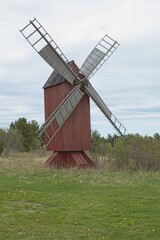 Old wooden red windmill on the island of Lemland in spring, Ahvenanmaa, Finland.