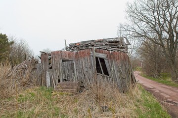 Old abandoned wooden building with huge damage.