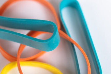 Rubber bands on a white background. Many colorful plastic rubber bands. Close up view