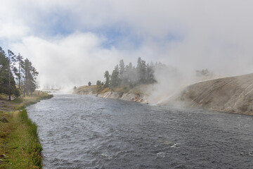 Fog banks over the Firehole River next to the Midway Geyser Basin in Yellowstone National Park