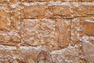 Stone wall covered with varnish close-up, background