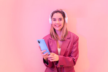 Smiling woman in headphones using smartphone