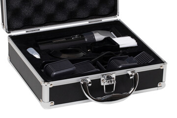 Closeup of a opened small black silver equipment case or suitcase with professional hairdresser's set isolated on a white background.