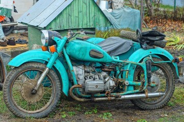 one old  iron rusty  classical  heavy big comfortable green power broken    dirty classic  retro industrial  motorcycle stands on the ground   on the street 
