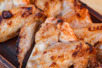 Barbecue chicken wings fried with crust, close-up, selective focus .