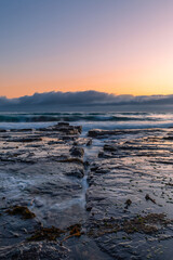 Sunrise view from the rocky coastline.