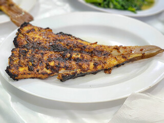 grilled biiter melon fish in plate