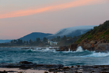 Scenic view of sea and mountain on the distance with fog.