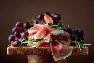 Prosciutto with grapes and rosemary.
