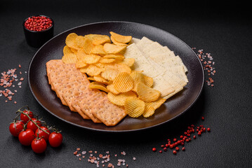 Crispy potato chips with salt, spices and herbs