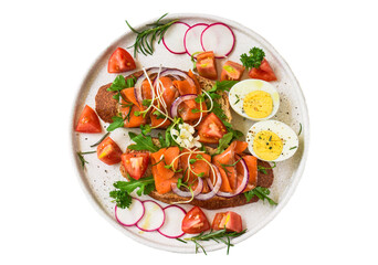 toast with smoked salmon, onion and vegetables on a white plate close up