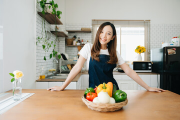 Asian woman preparing salad in the kitchen and healthy  food in bowl at home