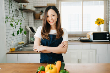 Asian woman preparing salad in the kitchen and healthy  food in bowl at home