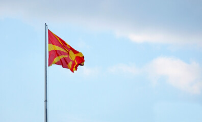The national flag of North Macedonia waving in the wind in Skopje