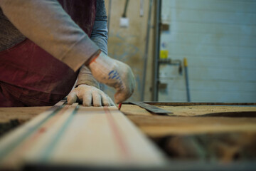 Measurement for cutting on raw wood, care taken. This ties to the artisanal trend of personalized home decor.