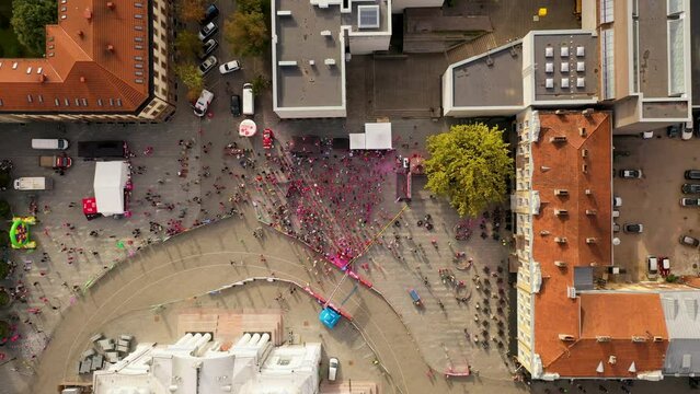 Drone footage of pre - marathon run warm up in a city center