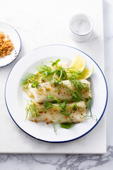 Baked white fish filet with green pea and lime
