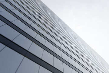 Fototapeta na wymiar High-rise modern building made of glass against the sky.