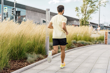 A runner runs in fitness clothes. Confidence in every day and training. Trainer exercise jogging.