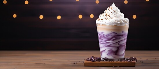 Iced taro latte topped with whipped cream Copy space image Place for adding text or design