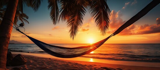 Hammock on palm trees at sunset representing carefree freedom on a tropical beach Summer nature exotic shore Tranquil travel paradise Enjoy life positive energy Copy space image Place for addin - obrazy, fototapety, plakaty