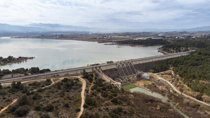 Obraz premium Aerial shot of the gravity dam for irrigation and water containment in Bellus, in the province of Valencia, Spain