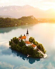 aerial view of a small island with a church in the middle: Bled, Slovenia