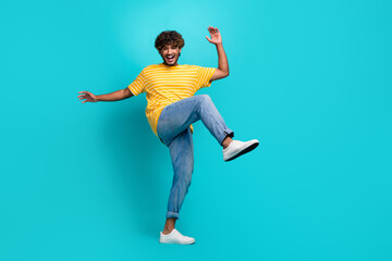Fototapeta na wymiar Full length portrait of carefree positive young man have fun dancing empty space isolated on turquoise color background