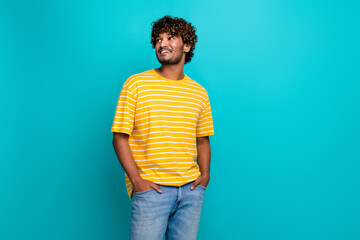 Photo portrait of attractive young man look empty space shopping dressed stylish striped yellow...