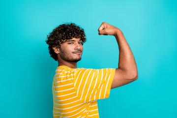 Photo portrait of attractive young man flex muscles dressed stylish striped yellow clothes isolated...