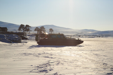 Hovercraft on the ice of winter Baikal near Khuzhir on a clear morning.