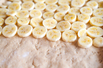 Sliced banana on dough when making banana pizza, close-up