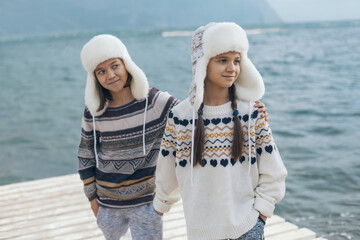 Children travelling in warm wool sweaters and winter hats.