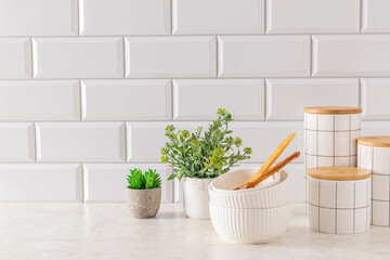 Beautiful kitchen background in white tones. A set of stylish ceramic jars for storing bulk...