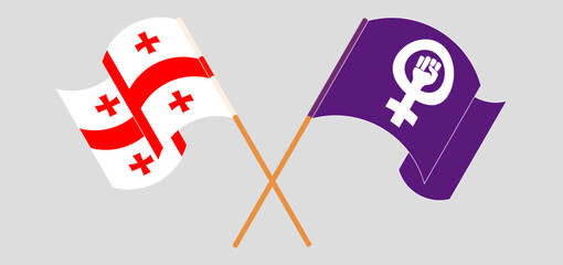 Fototapeta premium Crossed and waving flags of Georgia and Feminism