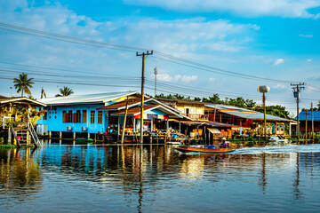  Longtail Boat Riding in a Canal Village © Parichart