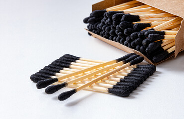 Cotton buds ear bamboo. Black cotton swabs on a light background. Environmentally friendly. Hygienic cotton swabs for many years. Copy space.