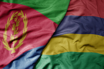 big waving national colorful flag of eritrea and national flag of mauritius .