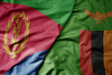 big waving national colorful flag of eritrea and national flag of zambia .