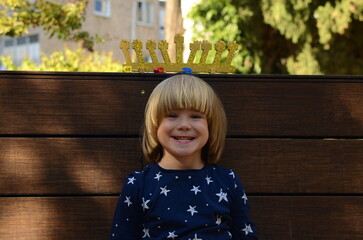 Cute child rejoices at Hanukkah. Children and Jewish holidays, Hanukkiah in the background....