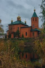 Obraz premium Orthodox church in the Dnieper near the water. St. Nicholas Church. Overcast weather. Religion, faith.
