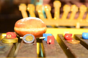 Hanukkah with wooden dreidels, menora,  sufganiyot, Chanukiahm coins shekel. Attributes of the...