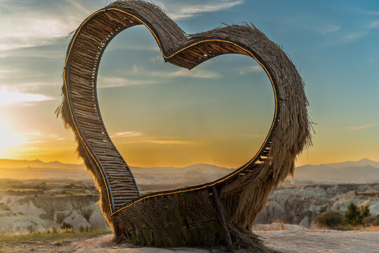 Structure In the Shape of a Heart, This Bench Is for Beautiful Romantic Photos, High in the Mountains Against the Backdrop of the Sunset. Images for Collage and Insertion of Any Person.