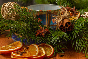 Christmas nature arrangement with dried orange pieces, cinnamon sticks, pine cones, star anise and Christmas tree branches