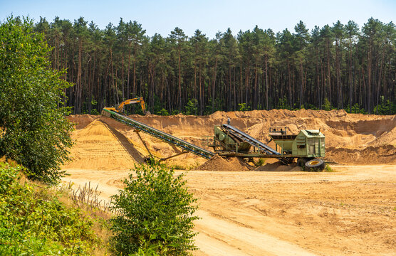 Sand quarry and mining equipment in the forest