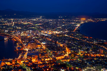Fototapeta premium sunset or sun rise of Hakodate cityscape with Skyline and office building and downtown of Hakodate is populars ciy from toursim Hokkaido, Japan with twilight sky in spring season
