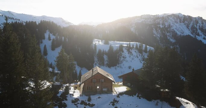 Wood house at mountain peak with winter snow panaroma and sunset - Tourist resort and chalet vacation concept 