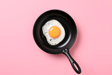 Fried egg on pan isolated on pink background